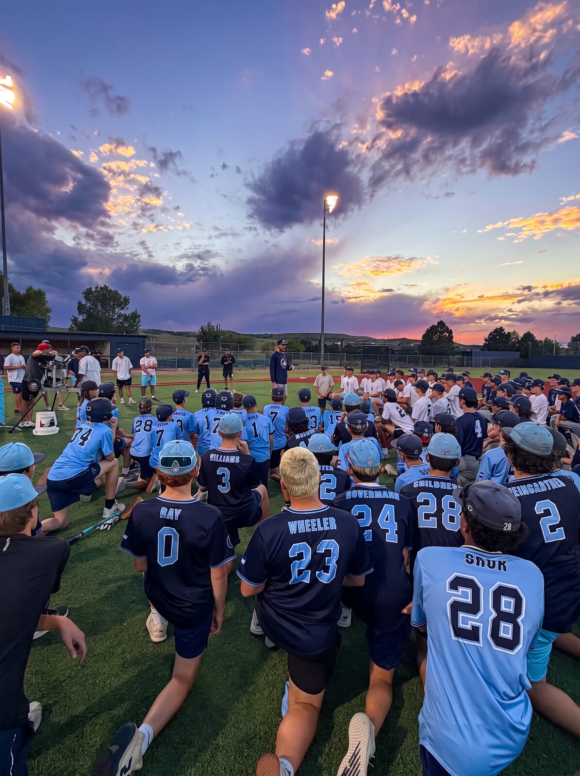 High school program players kneeling together during an evening team talk