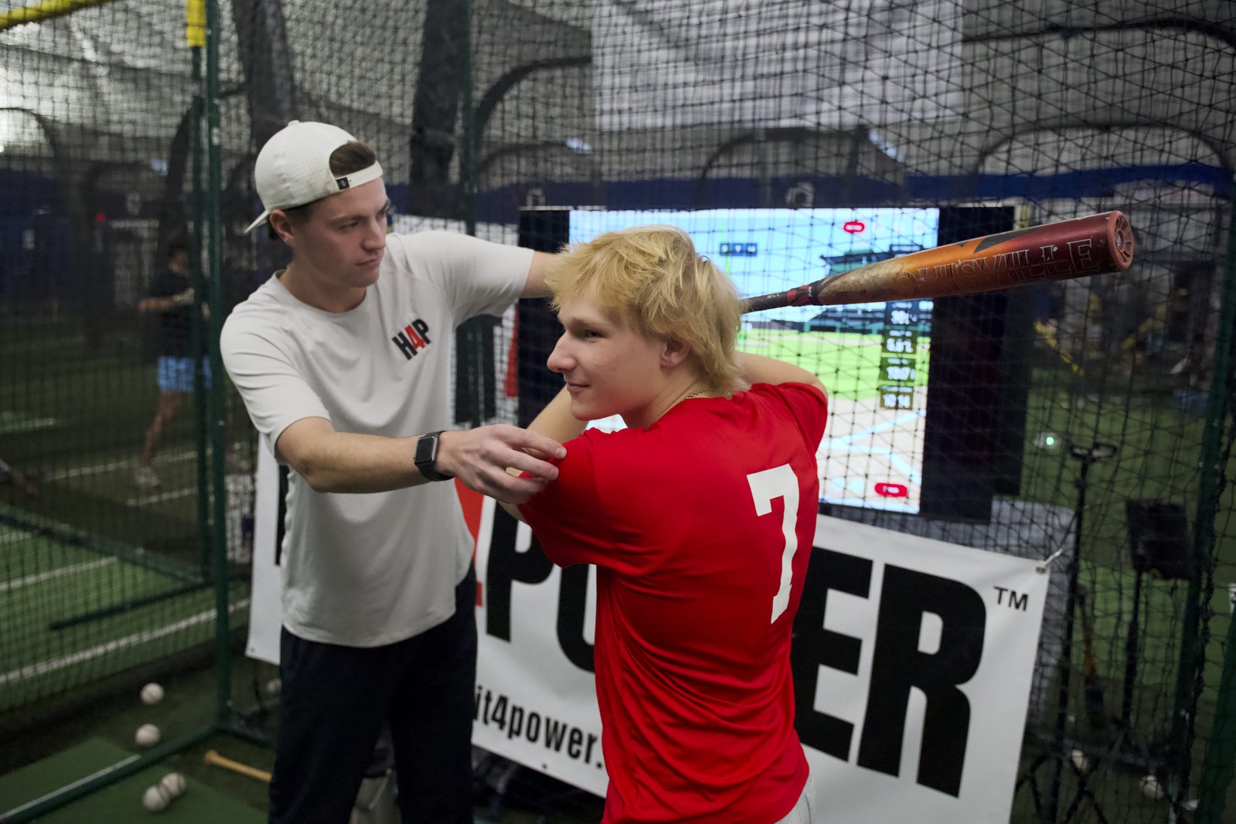 Gameday instructor working one-on-one with a youth hitter
