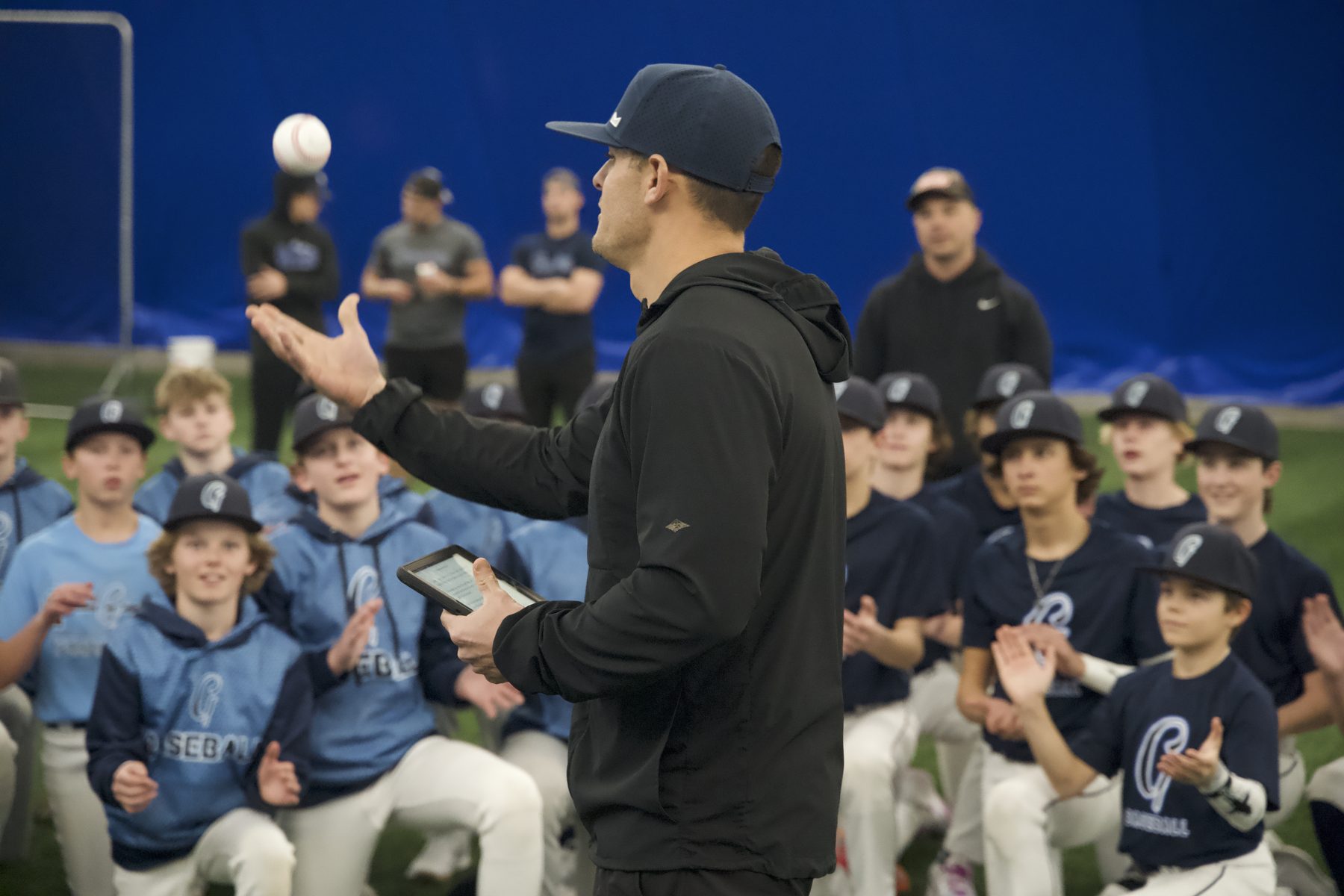Gameday coach leading a youth training session in the indoor dome