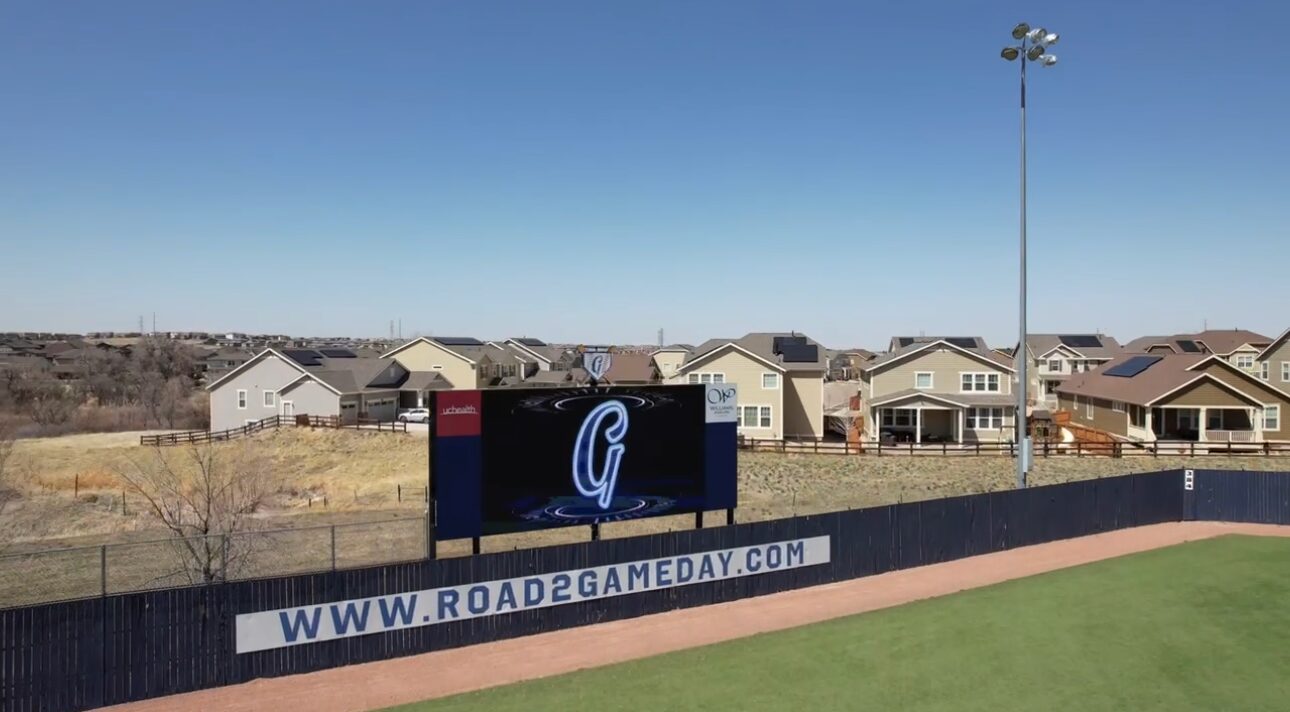 The lit HD jumbotron at Double Angel Ballpark with sponsor boards