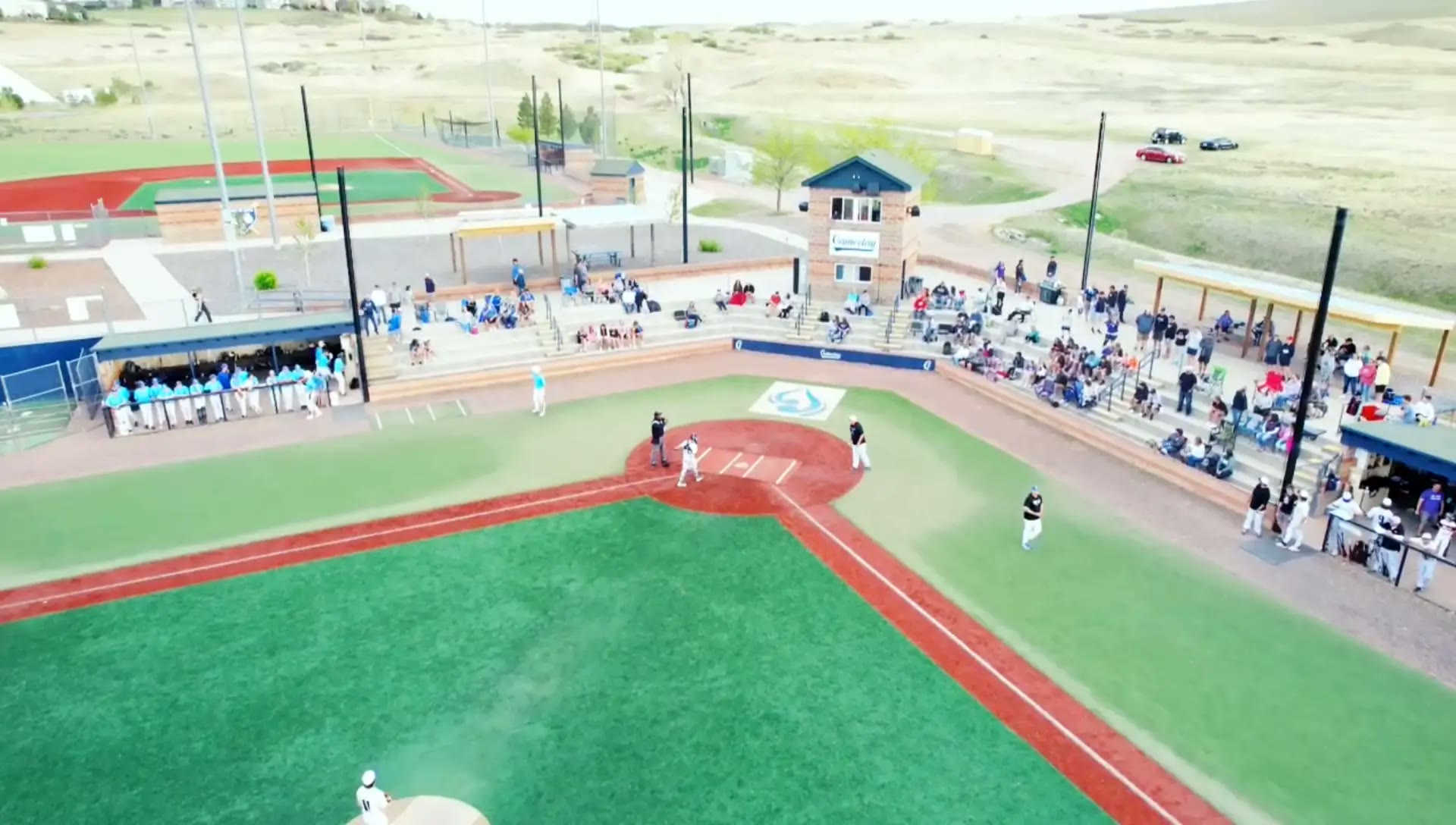 Families and fans around home plate by the Gameday entrance