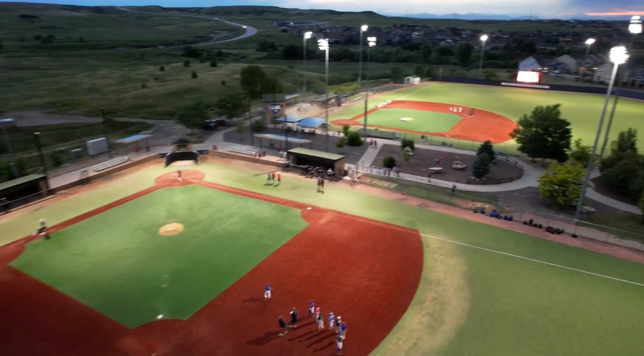 Dusk aerial of both lighted turf fields in Parker, CO
